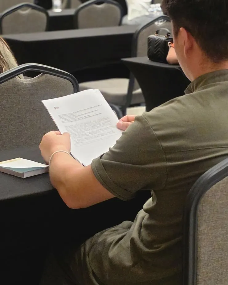 A participant reading the exam paper