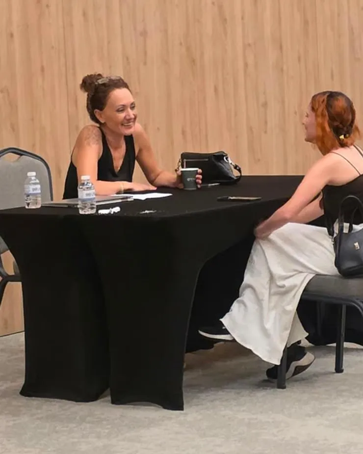 An assessor and a candidate seated opposite each other during a speaking test