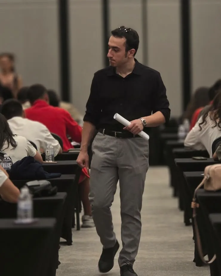 A Niz Eğitim invigilator walking between the desks during the assessment